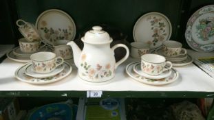 An Autumn leaves tea set including 6 cups, saucers & teapots etc.