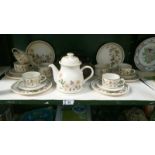 An Autumn leaves tea set including 6 cups, saucers & teapots etc.