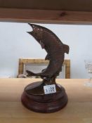 A brass fish on plinth with bronzed finish