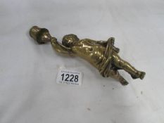A brass cherub candlestick,