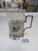 A Russian silver coffee can with the hammer and sickle and complete with glass liner