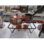 A double burner copper fondue set
