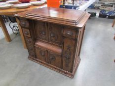 A Singer sewing machine in fine ornate cabinet