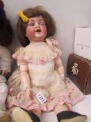An open mouthed porcelain headed doll with composition body by Simon & Halbig, 53cm/21",
