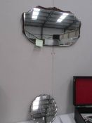 A 1930's bevel edged mirror and a smaller example