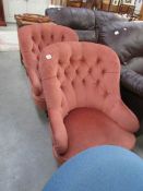 A pair of pink easy chairs