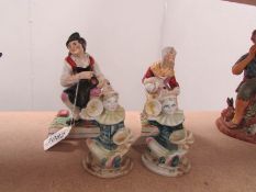 A pair of 19th century Staffordshire man and woman figures together with a pair of clown figures