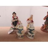 A pair of 19th century Staffordshire man and woman figures together with a pair of clown figures