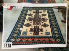 A blue, green and cream patterned rug, approximately 64.