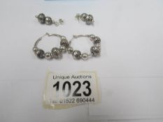 2 pairs of silver earrings,