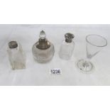 3 silver topped glass bottles and a cordial glass