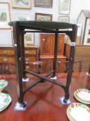 A circa 1940's 24" round folding card table with green baize on reverse side