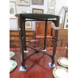 A circa 1940's 24" round folding card table with green baize on reverse side