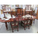 A mahogany extending dining table and 8 chairs