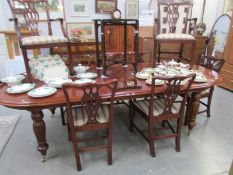 A mahogany extending dining table and 8 chairs