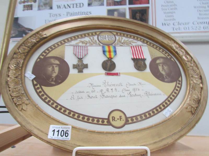 A framed and glazed set of 3 WW1 medals for the Battle of Verdun in oval frame