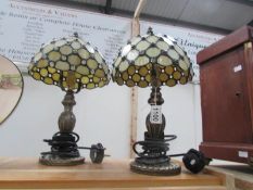 A pair of table lamps with Tiffany style shades