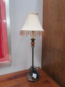 A bronze coloured table lamp with shade