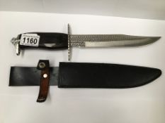 A hunting knife marked 'Stainless China' complete with scabbard