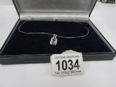 A 9ct gold pendant set topaz