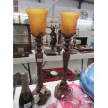 A pair of bronze colour table lamps with amber glass shades