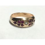 A diamond and ruby set 9ct gold ring,