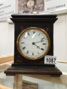 A Victorian lacquered mantel clock in working order