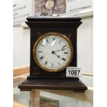 A Victorian lacquered mantel clock in working order