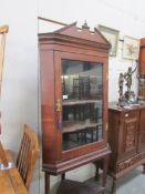 An oak corner cupboard on stand