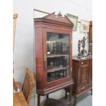 An oak corner cupboard on stand