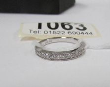 An 18kt white gold milligrain ring set with 14 diamonds,