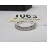 An 18kt white gold milligrain ring set with 14 diamonds,