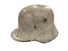A German military helmet (possibly M1916/M1917 type) with winter camouflage white paint (no liner)
