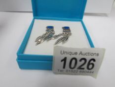 A pair of silver pendant earrings set lapis lazuli