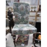 An upholstered chair on casters