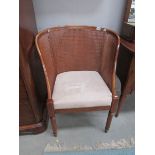 A cane backed arm chair