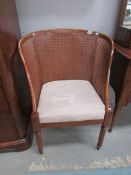 A cane backed arm chair