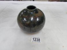 A treacle glazed studio pottery vase,