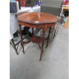 A mahogany side table with reeded legs