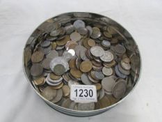 A tin of foreign coins