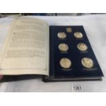 A presentation album of 24 gold plated silver Churchill centenary medallions produced by the