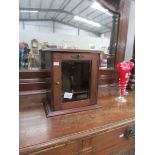 A smoker's cabinet with bevel edged glazed door