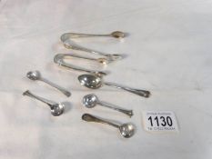 A pair of silver sugar nips, silver teaspoon and 4 silver salt spoons,