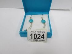 A pair of silver turquoise set earrings