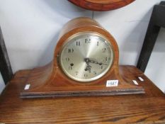 A mahogany inlaid mantel clock with key