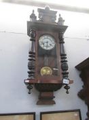 A Vienna style wall clock with key and pendulum
