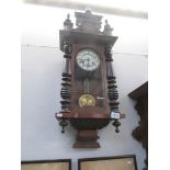 A Vienna style wall clock with key and pendulum