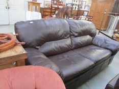 A dark brown leather sofa