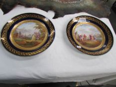 A pair of 19th century French hand painted and gilt harbour scene plates