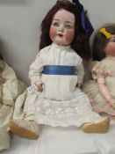 A porcelain headed doll marked Heubach Kopplesdorf, 32075, Germany, 60cm/22/75",